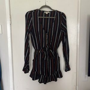 One piece romper button front w/tie, ruffle on hemline and cuffs